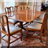F10. Historic Charleston Reproductions banded mahogany double pedestal table with 8 chairs, pads, and 2 20” leaves. Table: 30”h x 68”w x 46”d 